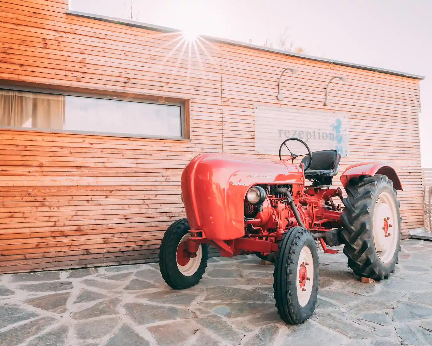 Czerwony traktor przed recepcją Gut Hügle